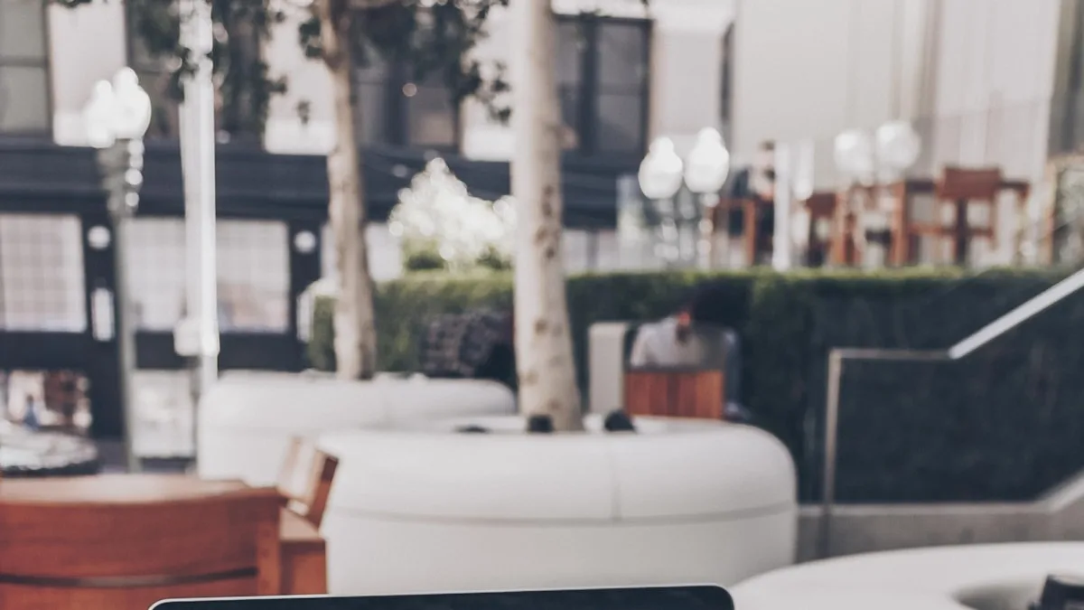 Web designer reviewing a website layout on a laptop